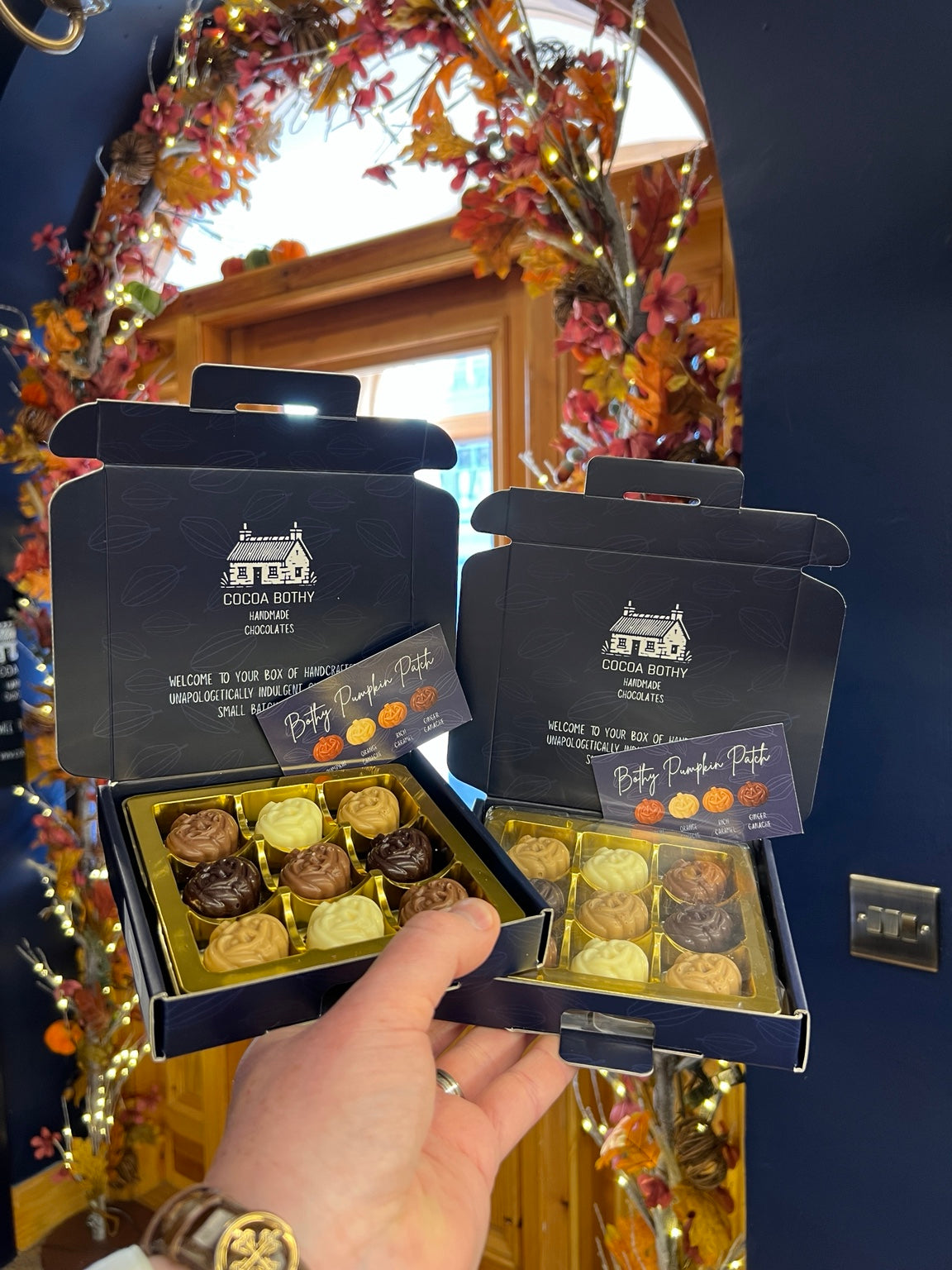 Cocoa Bothy Pumpkin Patch gift set of two nine-chocolate boxes with assorted pumpkin chocolates, photographed at the Steeple in autumn